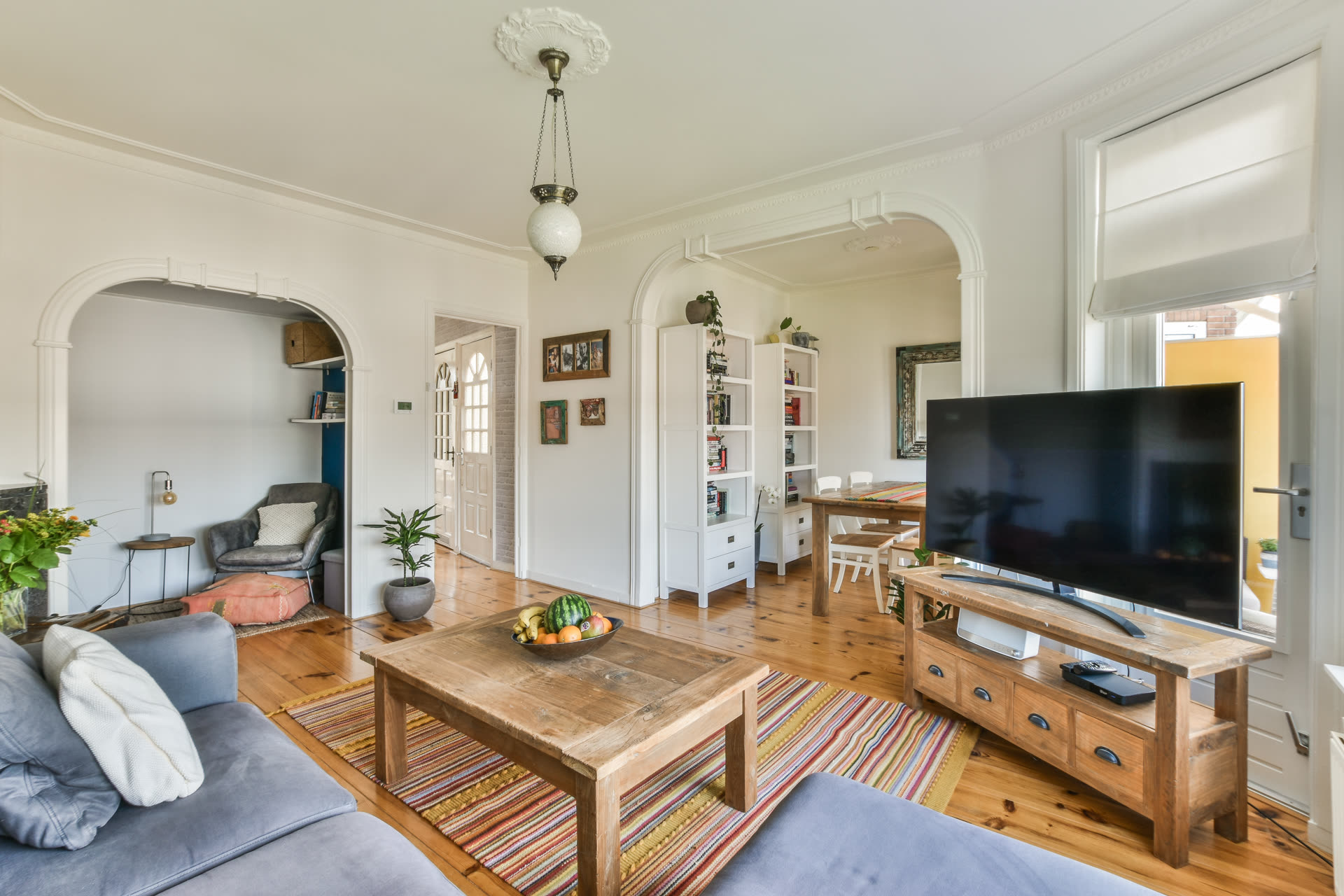 A renovated apartment interior in Lisbon, with natural-wood detailing and tilt windows.