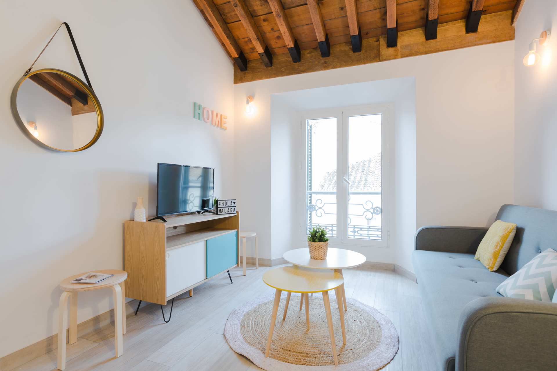 A cozy modern home interior with warm lighting, a sofa, and personal touches indicating someone lives there.